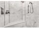 Beautiful marble shower with a built-in bench and modern fixtures at 3446 E Knoll St, Mesa, AZ 85213