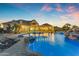 Resort-style pool with a waterfall feature, lush landscaping, and ample space for outdoor entertaining at 3446 E Knoll St, Mesa, AZ 85213