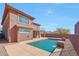 Expansive backyard featuring a pool with water features and an extended covered patio at 34714 N 21St Ln, Phoenix, AZ 85086
