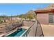Balcony view with pool, set against a beautiful desert backdrop with cacti and native vegetation at 34714 N 21St Ln, Phoenix, AZ 85086