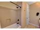 Bathroom featuring walk-in tub/shower, door to closet, and neutral color palette at 34714 N 21St Ln, Phoenix, AZ 85086