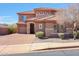 Attractive two story home with brick driveway, three car garage, rock facade, and desert landscaping at 34714 N 21St Ln, Phoenix, AZ 85086