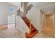 Open foyer with tile floor, wood staircase, and views of the formal living room at 34714 N 21St Ln, Phoenix, AZ 85086