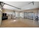 Well-organized garage featuring epoxy flooring, shelving, and ample space for storage and vehicles at 34714 N 21St Ln, Phoenix, AZ 85086
