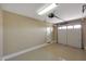 Clean garage with painted walls, bright lighting, and epoxy flooring at 34714 N 21St Ln, Phoenix, AZ 85086