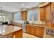 Bright kitchen with granite countertops, stainless steel appliances, wooden cabinets, and tiled flooring at 34714 N 21St Ln, Phoenix, AZ 85086