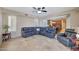 Open-concept living room with tile flooring and a large, comfortable sectional sofa at 34714 N 21St Ln, Phoenix, AZ 85086