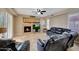 Cozy living room with fireplace, tile flooring, comfortable seating, and ample lighting at 34714 N 21St Ln, Phoenix, AZ 85086