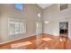 Bright living room featuring hardwood floors, plantation shutters, and high ceilings at 34714 N 21St Ln, Phoenix, AZ 85086