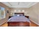 Comfortable main bedroom features hardwood floors, a tray ceiling, and neutral décor at 34714 N 21St Ln, Phoenix, AZ 85086