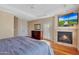 Spacious main bedroom features hardwood floors, a fireplace, tray ceiling, and natural light at 34714 N 21St Ln, Phoenix, AZ 85086