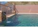 Close-up of a refreshing pool with stone water features, creating a tranquil backyard oasis at 34714 N 21St Ln, Phoenix, AZ 85086