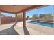 Covered patio with a view of the backyard pool area, providing a cool spot to relax and entertain at 34714 N 21St Ln, Phoenix, AZ 85086