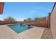 Beautiful swimming pool with relaxing stone waterfalls surrounded by desert landscaping and block fencing at 34714 N 21St Ln, Phoenix, AZ 85086