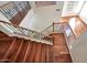 Interior staircase with wood stairs, wrought iron spindles, and hardwood floors at 34714 N 21St Ln, Phoenix, AZ 85086