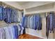 Organized walk-in closet featuring ample hanging space and built-in shelving for optimal storage at 34714 N 21St Ln, Phoenix, AZ 85086