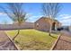 Backyard features green grass, gravel landscaping, and a view of the home's exterior at 3654 E Henson St, San Tan Valley, AZ 85140
