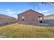 Exterior shot of the house from the backyard, showcasing the lawn and patio area at 3654 E Henson St, San Tan Valley, AZ 85140