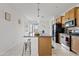 Modern kitchen with a granite island, stainless steel appliances, and bright natural light at 3654 E Henson St, San Tan Valley, AZ 85140
