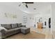 Bright and airy living room featuring neutral tile flooring and a comfortable gray sectional sofa at 3654 E Henson St, San Tan Valley, AZ 85140