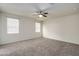 Spacious bedroom featuring carpet, neutral walls and two windows at 3736 S 244Th Dr, Buckeye, AZ 85326