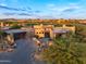Scenic aerial view of a modern desert home with lush landscaping near a golf course and other residences at 39877 N 107Th Way, Scottsdale, AZ 85262