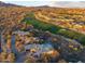 An aerial view featuring the home, golf course, community and landscape highlighting the homes setting near the golf course at 39877 N 107Th Way, Scottsdale, AZ 85262