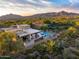 An aerial view showcasing home's private backyard and landscape featuring pool, lounge, and proximity to the desert surroundings at 39877 N 107Th Way, Scottsdale, AZ 85262