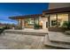 Back patio featuring an outdoor kitchen, gas grill, a large travertine tiled patio, and backyard access at 39877 N 107Th Way, Scottsdale, AZ 85262