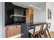 Stylish bar area with black backsplash, wooden cabinets, and counter seating at 39877 N 107Th Way, Scottsdale, AZ 85262