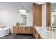 The bathroom features a tub, white countertops, tile floors, and wood cabinets at 39877 N 107Th Way, Scottsdale, AZ 85262
