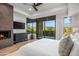 Main bedroom with fireplace, flat screen tv, and backyard views and access at 39877 N 107Th Way, Scottsdale, AZ 85262