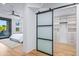 View of the bedroom through the closet, featuring a sliding frosted glass door at 39877 N 107Th Way, Scottsdale, AZ 85262