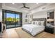Main bedroom with backyard views, ceiling fan, and neutral tones at 39877 N 107Th Way, Scottsdale, AZ 85262