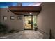 Modern home entrance with clean lines, desert landscaping, and a stylish glass front door at 39877 N 107Th Way, Scottsdale, AZ 85262