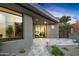 Contemporary home exterior featuring desert landscaping and a covered walkway towards the entrance at 39877 N 107Th Way, Scottsdale, AZ 85262