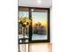 Elegant foyer view showcasing a glass table with flowers and a backyard view with a sunset at 39877 N 107Th Way, Scottsdale, AZ 85262