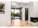 Open foyer view with a fireplace and a glass table with flowers overlooking a picturesque backyard sunset at 39877 N 107Th Way, Scottsdale, AZ 85262