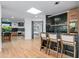 Bright and airy kitchen with black backsplash, skylight and island with seating at 39877 N 107Th Way, Scottsdale, AZ 85262