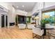 Open concept living room with a fireplace, hardwood floors, and modern lighting at 39877 N 107Th Way, Scottsdale, AZ 85262