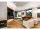 Modern living room with a fireplace, hardwood floors, and a comfortable seating arrangement at 39877 N 107Th Way, Scottsdale, AZ 85262