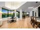 Spacious living space featuring modern dining area, kitchen, hardwood floors, and natural light at 39877 N 107Th Way, Scottsdale, AZ 85262