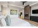 This is the bedroom featuring a fireplace, sleek furniture, and wood floors at 39877 N 107Th Way, Scottsdale, AZ 85262