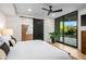 Bright main bedroom boasting hardwood floors, a sliding barn door, and backyard access through glass doors at 39877 N 107Th Way, Scottsdale, AZ 85262