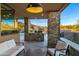 Relaxing outdoor seating area with a stone-clad BBQ and mountain views, perfect for outdoor entertainment and relaxation at 39877 N 107Th Way, Scottsdale, AZ 85262