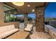 Outdoor covered living space featuring a grill, seating, and stone pillars at 39877 N 107Th Way, Scottsdale, AZ 85262