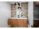 Modern powder room featuring floating vanity with wood cabinets, accent wall tile, pendant lights, and modern fixtures at 39877 N 107Th Way, Scottsdale, AZ 85262
