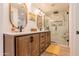 Elegant bathroom featuring double vanities with wooden cabinets, modern fixtures, and a glass-enclosed shower at 406 W Coolidge St, Phoenix, AZ 85013