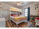Bright bedroom with a bunk bed and playful décor, featuring a large window and vibrant rug at 406 W Coolidge St, Phoenix, AZ 85013