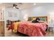 Cozy bedroom featuring a comfortable bed with decorative pillows, a ceiling fan, and ample natural light at 406 W Coolidge St, Phoenix, AZ 85013